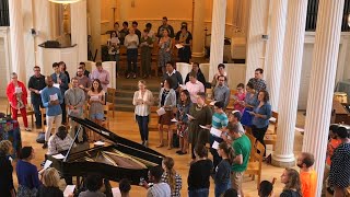 Worshippers singing together in Marquand Chapel around piano