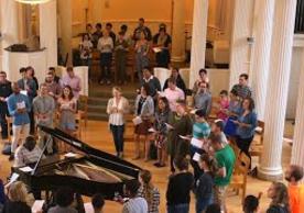 Worshippers singing together in Marquand Chapel around piano